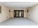 A covered entrance with beautiful double doors, exterior lights, and views of the front yard at 4157 Marine Pkwy, New Port Richey, FL 34652
