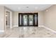 Bright foyer with marble tile flooring and a large front door with sidelights, and a view into the bathroom at 4157 Marine Pkwy, New Port Richey, FL 34652