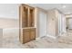 Hallway with wood cabinet featuring glass doors, multiple closets, and marble tiled flooring at 4157 Marine Pkwy, New Port Richey, FL 34652