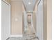 Hallway with multiple white doors, neutral paint, and marble tiled flooring at 4157 Marine Pkwy, New Port Richey, FL 34652