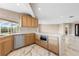 Charming kitchen with light wood cabinets, marble backsplash, and stainless steel appliances at 4157 Marine Pkwy, New Port Richey, FL 34652