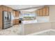 Modern kitchen featuring stainless steel appliances, natural wood cabinetry, and bright countertops at 4157 Marine Pkwy, New Port Richey, FL 34652