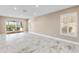 Bright living room with sliding glass doors opening to a lanai and a screened-in patio at 4157 Marine Pkwy, New Port Richey, FL 34652
