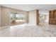 Spacious living area with sliding doors to the lanai, open floorplan, and marble-look tile floors at 4157 Marine Pkwy, New Port Richey, FL 34652