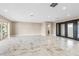 Spacious living room with sliding glass doors to the lanai and marble tile flooring at 4157 Marine Pkwy, New Port Richey, FL 34652