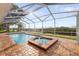 Enclosed pool with brick patio and view of the peaceful canal at 4157 Marine Pkwy, New Port Richey, FL 34652