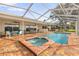 Beautiful screened in pool with spa and brick patio perfect for entertaining at 4157 Marine Pkwy, New Port Richey, FL 34652