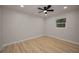 Well-lit bedroom showcasing laminate floors, a ceiling fan and a window at 4441 16Th N St, St Petersburg, FL 33703