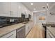 Bright kitchen with stainless steel appliances, granite countertops, and black tile backsplash at 4441 16Th N St, St Petersburg, FL 33703