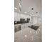 Modern kitchen with updated light fixture, granite countertops, stainless steel appliances and an island with cooktop at 4441 16Th N St, St Petersburg, FL 33703