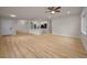 Open-concept living room with kitchen view, featuring recessed lights, ceiling fan and wood-look floors at 4441 16Th N St, St Petersburg, FL 33703