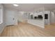 Bright, open-concept living space showcasing modern flooring, neutral walls, and a view into the kitchen at 4441 16Th N St, St Petersburg, FL 33703