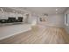 Open-concept living room with modern flooring and abundant natural light, seamlessly connected to the kitchen at 4441 16Th N St, St Petersburg, FL 33703