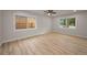 Bright living room with two windows, ceiling fan, recessed lighting and wood-look floors at 4441 16Th N St, St Petersburg, FL 33703