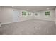 Well-lit living room with carpet flooring and multiple windows at 4441 16Th N St, St Petersburg, FL 33703