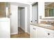 Bathroom with walk-in closet and updated vanity with granite countertop at 4611 W 18Th Ave, Bradenton, FL 34209
