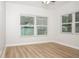 Bedroom featuring new wood-look flooring, neutral paint, and bright natural light at 4611 W 18Th Ave, Bradenton, FL 34209