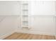 Spacious walk-in closet with built-in shelving and laminate flooring, ideal for storage at 4611 W 18Th Ave, Bradenton, FL 34209