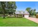 Charming one-story brick home featuring a large front yard with mature trees and manicured landscaping at 4611 W 18Th Ave, Bradenton, FL 34209
