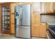 Kitchen boasts stainless steel refrigerator and wooden cabinets at 4611 W 18Th Ave, Bradenton, FL 34209