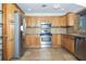 Kitchen features wooden cabinets, stainless steel appliances, and tile flooring at 4611 W 18Th Ave, Bradenton, FL 34209