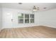 Bright living room with wood-look flooring, white walls, and abundant natural light at 4611 W 18Th Ave, Bradenton, FL 34209