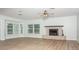 Spacious living room features a brick fireplace, wood-look flooring and neutral paint at 4611 W 18Th Ave, Bradenton, FL 34209