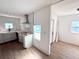 Bright kitchen with white cabinets, new stainless hood and sink fixture, and wood-look flooring at 4701 17Th S Ave, St Petersburg, FL 33711