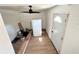 Living room with new flooring, ceiling fan, and a white door provides a modern and functional space at 4701 17Th S Ave, St Petersburg, FL 33711
