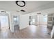 Spacious and bright living room with new flooring, modern lighting, and white walls at 4701 17Th S Ave, St Petersburg, FL 33711