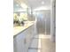 Bathroom featuring white cabinets, granite countertops, framed mirrors, and a glass shower at 4957 Seafoam Trl, Bradenton, FL 34211