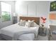 Bright bedroom featuring neutral walls, large windows, and views of the yard at 4957 Seafoam Trl, Bradenton, FL 34211