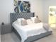 Well-lit bedroom features a decorative headboard, bedside table, and views into the bathroom at 4957 Seafoam Trl, Bradenton, FL 34211