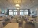 Clubhouse area features ample seating, tables and chairs, televisions, and plant decor at 4957 Seafoam Trl, Bradenton, FL 34211
