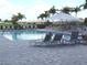 Resort style pool with chairs, lounge chairs, and umbrellas at 4957 Seafoam Trl, Bradenton, FL 34211