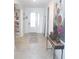 Bright and inviting entryway featuring neutral tile flooring, white walls, and elegant decor at 4957 Seafoam Trl, Bradenton, FL 34211