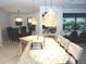 Bright kitchen features a granite island with stainless steel appliances, pendant lighting, and backyard pool view at 4957 Seafoam Trl, Bradenton, FL 34211