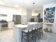 Modern eat-in kitchen featuring stainless steel appliances, granite countertops and a center island with pendant lighting at 4957 Seafoam Trl, Bradenton, FL 34211