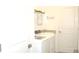 Well-lit laundry room features a modern washer and dryer with a granite countertop sink at 4957 Seafoam Trl, Bradenton, FL 34211
