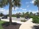 Community parking lot with golf cart parking and palm tree landscaping under a blue sky with white clouds at 4957 Seafoam Trl, Bradenton, FL 34211