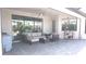 This patio has seating, a ceiling fan, sliding glass doors, and a view of the pool at 4957 Seafoam Trl, Bradenton, FL 34211
