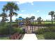 Colorful community playground with slides, climbing structures, and palm trees at 4957 Seafoam Trl, Bradenton, FL 34211