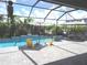 Relaxing backyard pool with lounge chairs, umbrellas and a calming fountain at 4957 Seafoam Trl, Bradenton, FL 34211