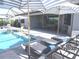 Relaxing backyard pool with lounge chairs and umbrellas at 4957 Seafoam Trl, Bradenton, FL 34211