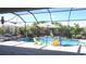 Relaxing backyard pool with lounge chairs, umbrellas and manicured landscape at 4957 Seafoam Trl, Bradenton, FL 34211