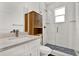 Bright bathroom featuring a white vanity with stone countertop, alongside a glass enclosed shower at 5006 W Idaho St, Tampa, FL 33616