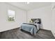 Bedroom featuring large window, gray floors, light walls, and a playful decorated bed at 5006 W Idaho St, Tampa, FL 33616