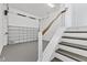 Interior view of garage and stairs with railings leading to home at 5006 W Idaho St, Tampa, FL 33616