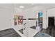 Bright hallway featuring modern staircase with wood treads and metal cable railing leading to bedroom at 5006 W Idaho St, Tampa, FL 33616