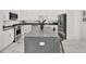 Bright kitchen featuring white cabinets, marble floors, gray counters, and a spacious center island with bar seating at 5006 W Idaho St, Tampa, FL 33616